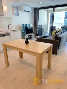 a kitchen and living room with a wooden table at Splendid 2bd 1bth 1csp Apt - Superb CBD Location in Canberra