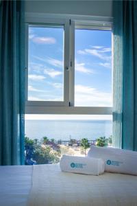 a bedroom with a bed with a view of the ocean at MARBELLA BANUS SUITES - Marbella Centre Sea Views Suite Apartment in Marbella