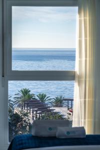 a view of the ocean from a bedroom window at MARBELLA BANUS SUITES - Marbella Centre Sea Views Suite Apartment in Marbella