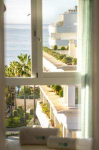 a window view of the ocean from a hotel room at MARBELLA BANUS SUITES - Marbella Centre Sea Views Suite Apartment in Marbella