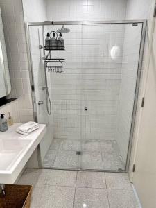 a shower with a glass door in a bathroom at Industrial yet Modern, 1bd 1bth Apt - Woden in Phillip