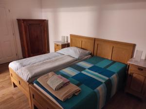a bedroom with a bed with a blue and striped blanket at Ubytování U Giordanů in Slavonice