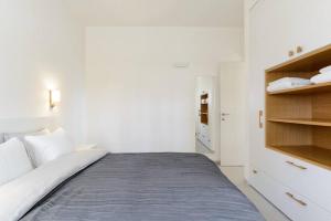 a white bedroom with a bed and a closet at New 2bedroom apt, view to the sea and Neve Tzedek in Tel Aviv