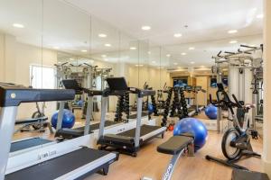 a gym with a lot of exercise equipment and a mirror at New 2bedroom apt, view to the sea and Neve Tzedek in Tel Aviv