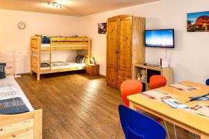 a room with a table and chairs and a bunk bed at Ferienwohnung beim Europa-Park Rust in Rust