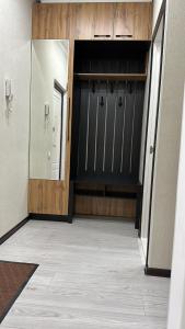a room with two garage doors and a hallway at Двухкомнатная квартира in Shymkent