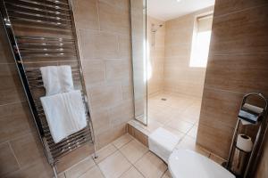 a bathroom with a shower and a toilet at The Sir Thomas Hotel in Liverpool