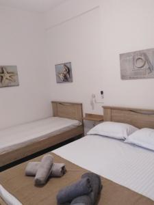 two beds in a room with towels on them at NIKI STAVROS COMFORT STUDIOS in Stavros