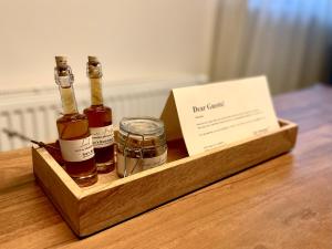 une boîte en bois avec trois bouteilles d'alcool sur une table dans l'établissement Ian's Residence, à Kranjska Gora