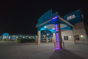 a gas station with a lit up sign in front of it at Hotel Bliss Kemah in Kemah