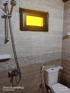 eine Dusche im Bad mit WC und Fenster in der Unterkunft Mermaid camp in Nuweiba