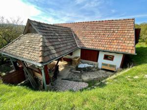 a small house with a roof on a hill at Nature Lodge Csesztve in Csesztve