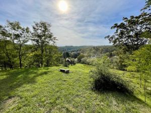 a park bench sitting on a grassy hill at Nature Lodge Csesztve in Csesztve