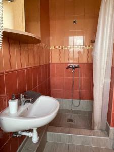 a bathroom with a sink and a shower at Airport Szálló in Tököl +39 photos