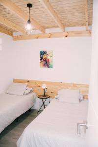 two beds in a room with wooden ceilings at Casa Beta in Buenavista del Norte