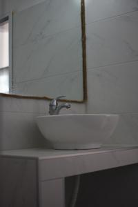 a white sink sitting on a counter in a bathroom at Golden Beach Hotel in Metamorfosi