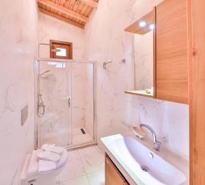 a white bathroom with a shower and a sink at Park Mandalin Hotel - Adult only in Ağva +37 photos