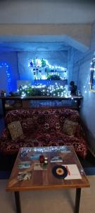 a room with a table and a couch with lights at Authentic Belgrade Centre Hostel - Only private rooms in Belgrade