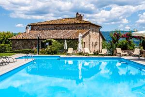 a villa with a swimming pool in front of a building at Agriturismo Fattoria Lavacchio in Pontassieve