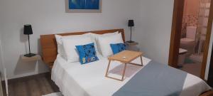 a bedroom with a bed with a table on it at Suite Bucica in Teguise