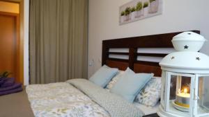 una camera da letto con un letto con una lanterna sopra di Apartamento Estelas de Cantabria a Los Corrales de Buelna