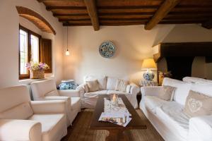 a living room with white couches and a table at Agriturismo Fattoria Lavacchio in Pontassieve