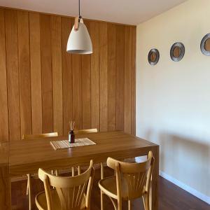 comedor con mesa de madera y sillas en Hermoso y amplio departamento de categoria en San Carlos de Bariloche