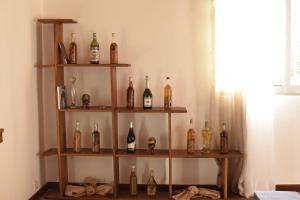 a shelf filled with lots of bottles of wine at Villa paisible proche des rizières in Antananarivo