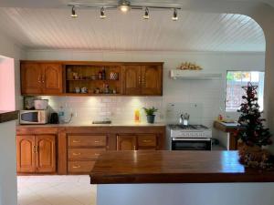 a kitchen with wooden cabinets and a christmas tree in it at Villa paisible proche des rizières in Antananarivo