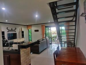 a kitchen and living room with a spiral staircase at BEA Privileged Apartment in Lamai