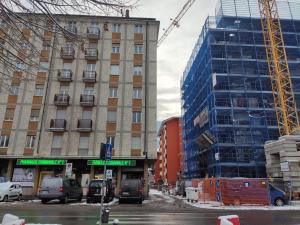 a building under construction with cars parked in front of it at Shared bathroom - MyAostaProject in Aosta