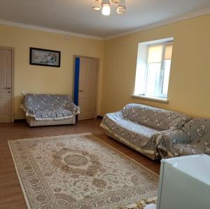 a living room with two beds and a couch at Гостевой дом Самурук in Atyrau