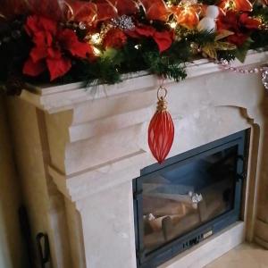 a fireplace with a christmas ornament on it at Chalet Zolota Pidkova in Slavske
