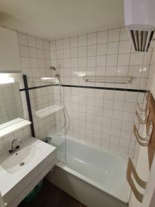 a white bathroom with a sink and a shower at Résidence Le fägot à Valmorel- studio 4 personnes in Valmorel