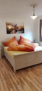 a bed in a room with a wooden floor at Haus Senn in Seefeld in Tirol