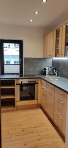 a kitchen with wooden cabinets and a stove top oven at Haus Senn in Seefeld in Tirol