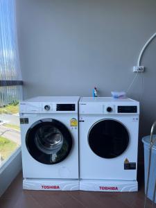 two washing machines sitting next to each other at The Regent Bangtao Apartments in Bang Tao Beach