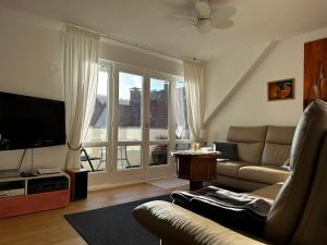 a living room with a couch and a large window at Spatzennest in Bad Harzburg