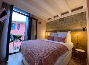 a bedroom with a large bed and a large window at Demeure Terrisse La Résidence in Marseillan +24 photos