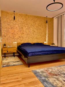 a bedroom with a bed and a stone wall at Blancris Boutique in Braşov