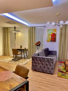 a living room with a couch and a table at Blancris Boutique in Braşov