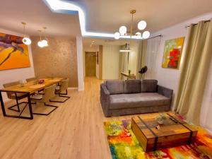a living room with a couch and a table at Blancris Boutique in Braşov