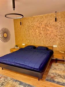 a bedroom with a bed and a stone wall at Blancris Boutique in Braşov