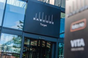 a building with a sign on the side of it at Spacious modern 2BR apartment at Central OSLO BARCODE in Oslo
