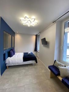 Schlafzimmer mit einem Bett und einem Kronleuchter in der Unterkunft Hôtel-restaurant La bonne hôtesse in Chambon-sur-Lac