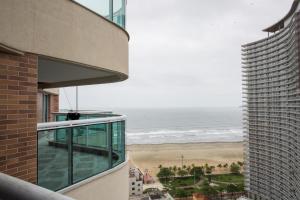 a view of the beach from the balcony of a building at Estanconfor Santos com Vista Mar 2 in Santos