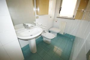 a bathroom with a sink and a toilet at Appartamenti La Mer in San Benedetto del Tronto +10 photos