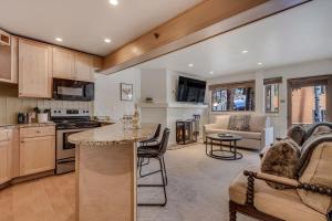 a kitchen and living room with a couch and a table at Laurelwood Condominiums 103 in Snowmass Village