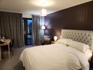 a bedroom with a large white bed and a window at The Swan - A Colombo Edition Hotel in Ely