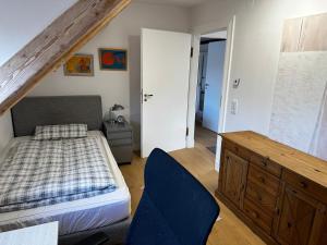 a bedroom with a bed and a dresser in it at Spatzennest in Bad Harzburg
